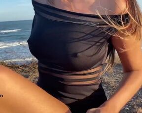 Girl with hard nipples masturbating on public beach